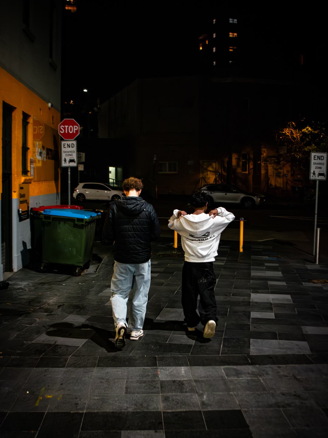 Friends walking off into the distance at night